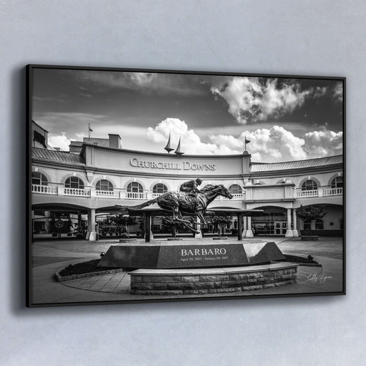 Main Image – Black and white fine art photo of Churchill Downs entrance with the Barbaro statue in foreground beneath dramatic clouds.