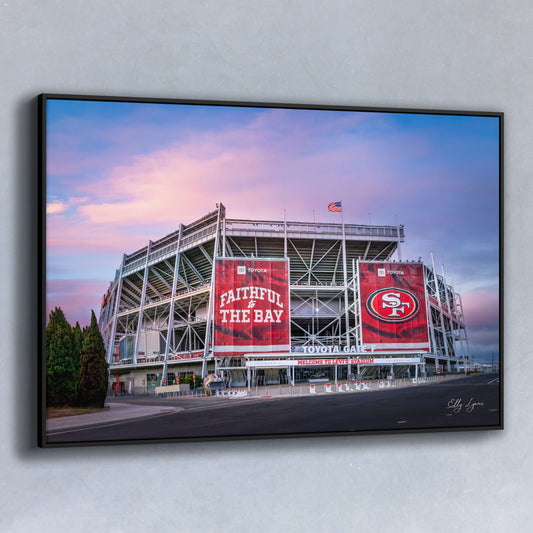 Fine art photograph of Levi’s Stadium at sunrise with bold red “Faithful to the Bay” banners on display.