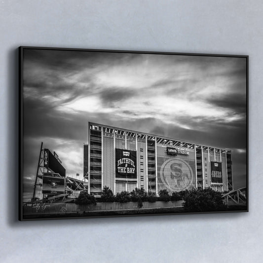 Black and white fine art photo of Levi’s Stadium at sunset, with dramatic sky above and banners reading “Faithful to the Bay” and “49ers,” ideal for fans and collectors.
