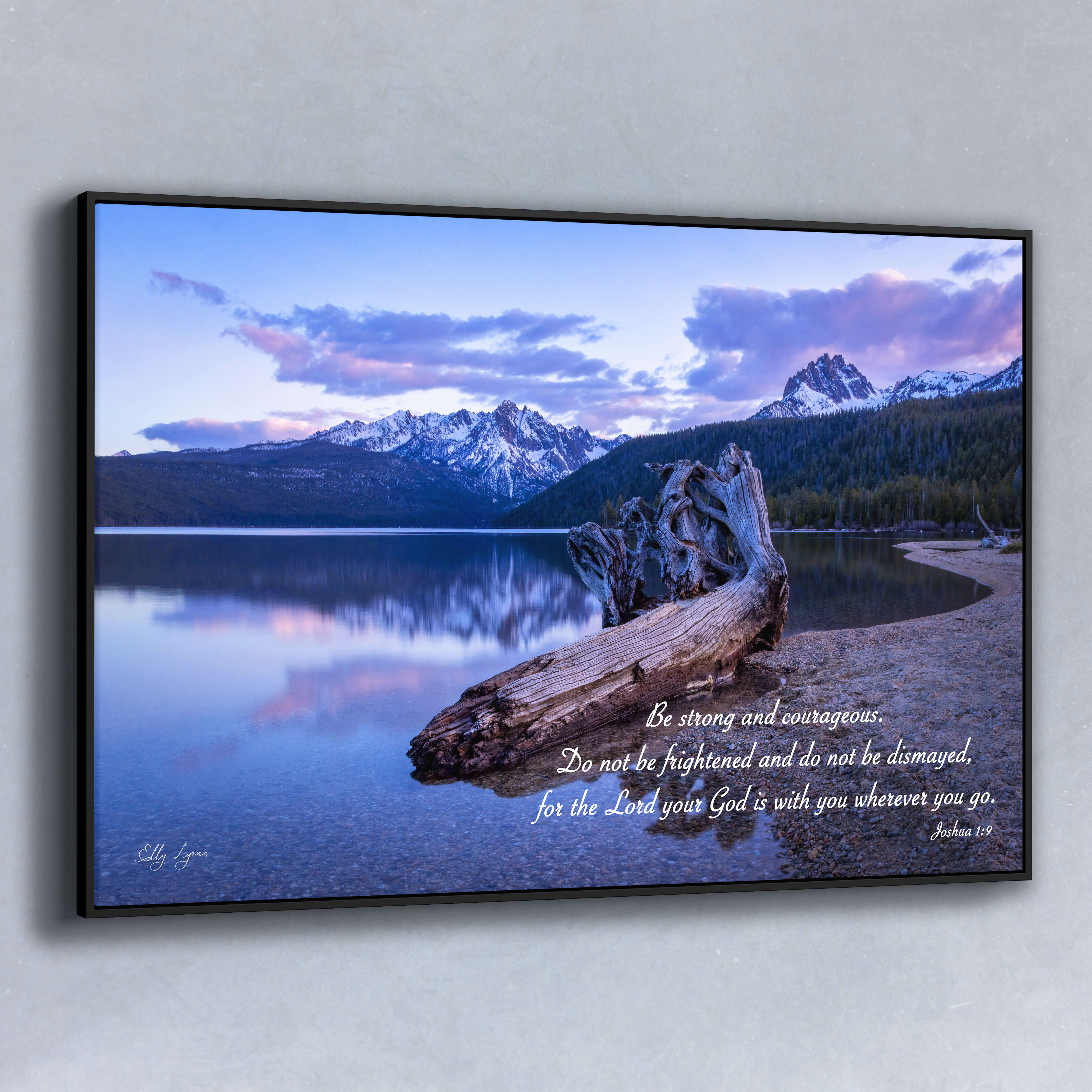 Peaceful mountain lake fine art print with Joshua 1:9 scripture, “Be strong and courageous,” and driftwood foreground.