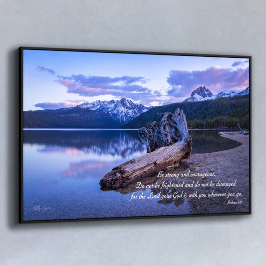 Peaceful mountain lake fine art print with Joshua 1:9 scripture, “Be strong and courageous,” and driftwood foreground.
