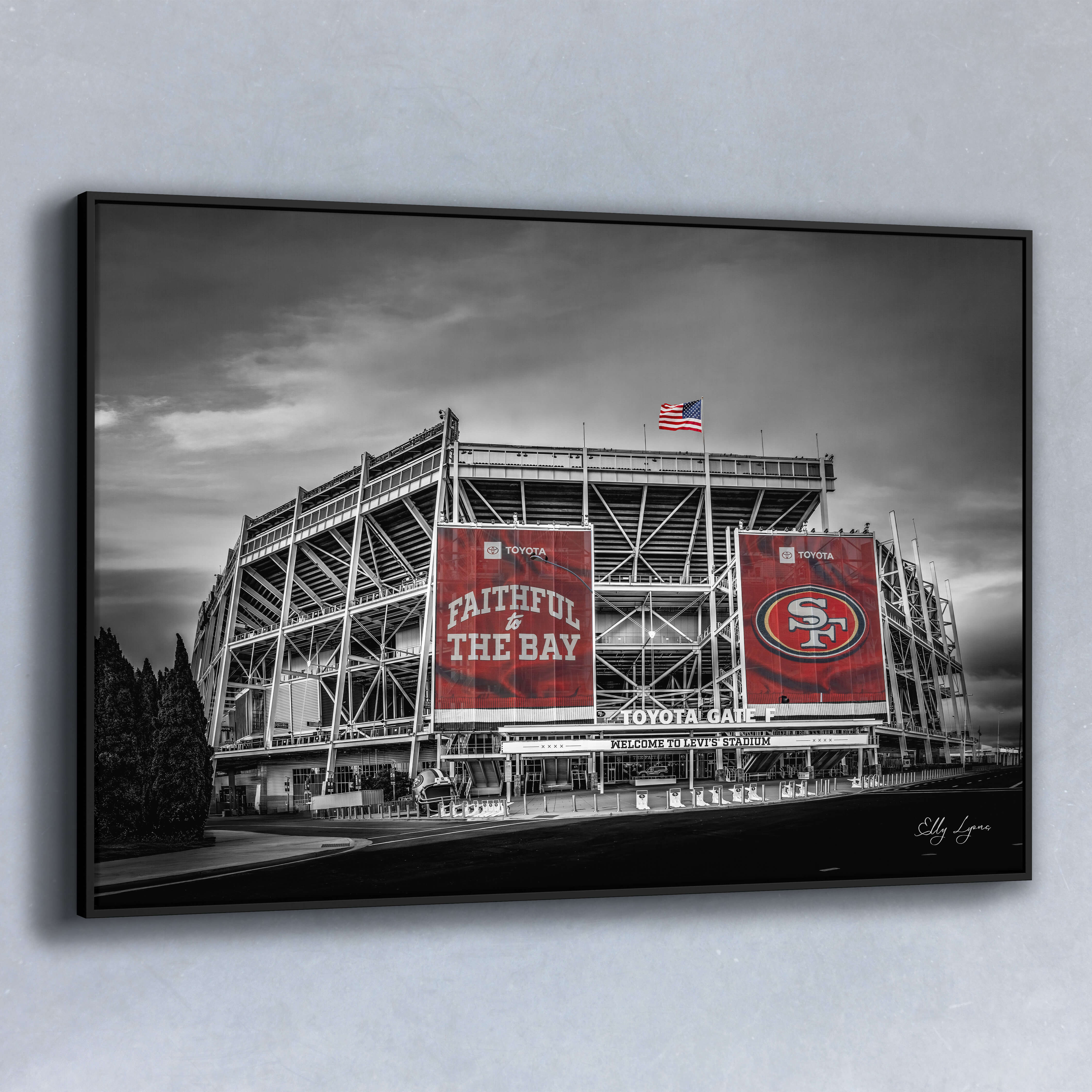Black and white fine art print of Levi’s Stadium with vivid red “Faithful to the Bay” and 49ers banners standing out in bold contrast.