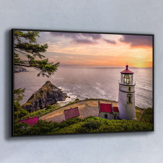 Golden sunset over Heceta Head Lighthouse on Oregon Coast with red roofs and sweeping ocean views.