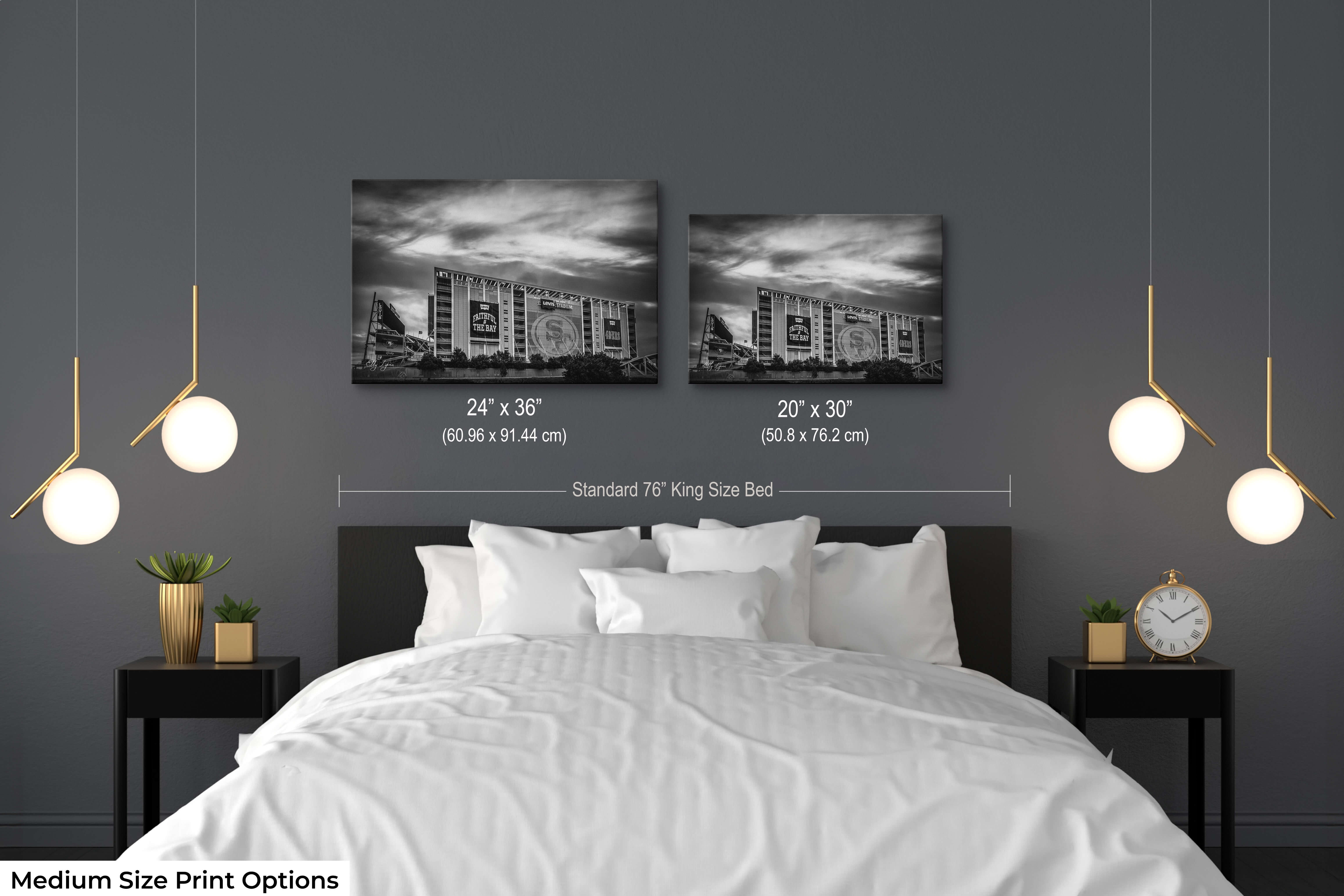 Two medium-sized black and white stadium prints (20x30 and 24x36) above a king-sized bed, highlighting size and layout for bedroom wall decor.